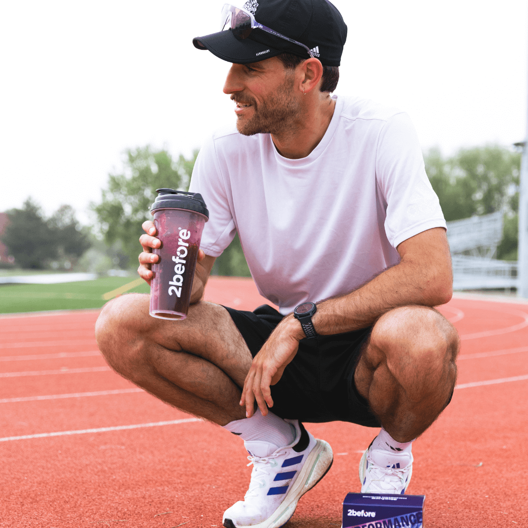Runner on track drinking black currant powder